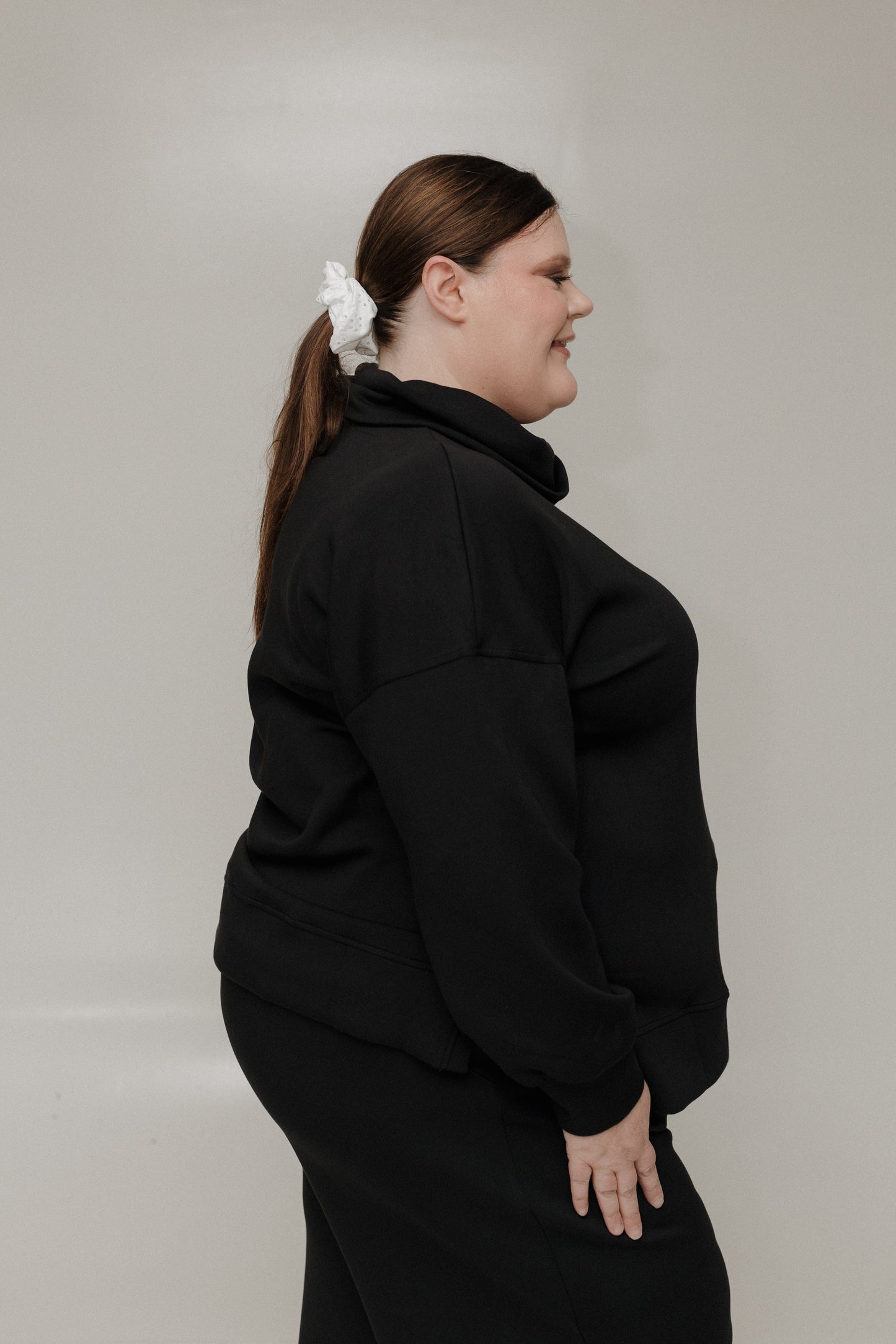 Person wearing a black outfit with a white background