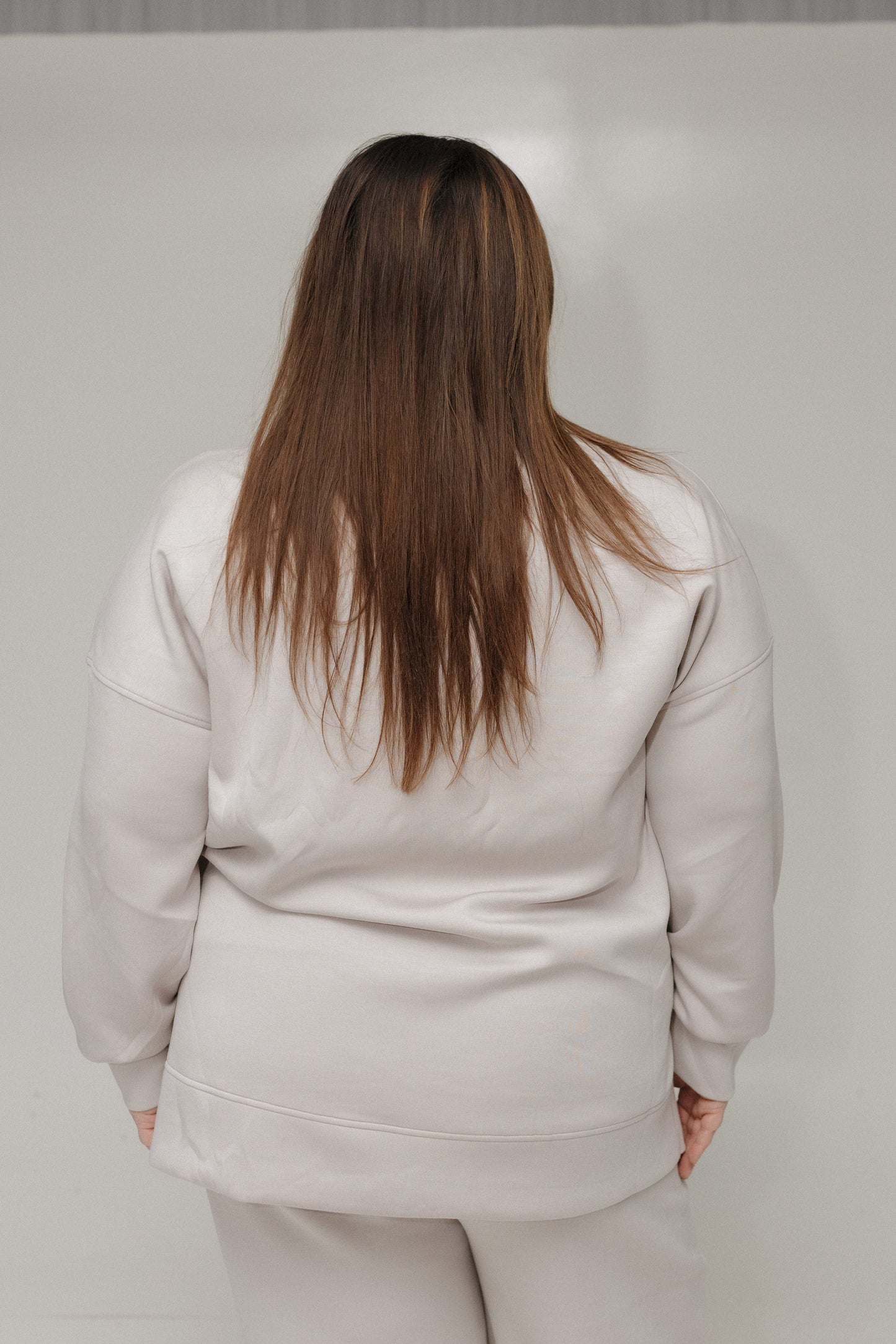 Back of Spanx AirEssentials Turtleneck tunic against a white background