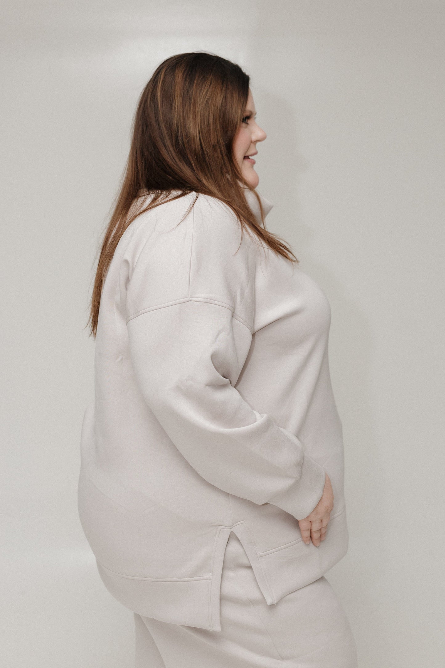 Side of Spanx AirEssentials Turtleneck tunic against a white background