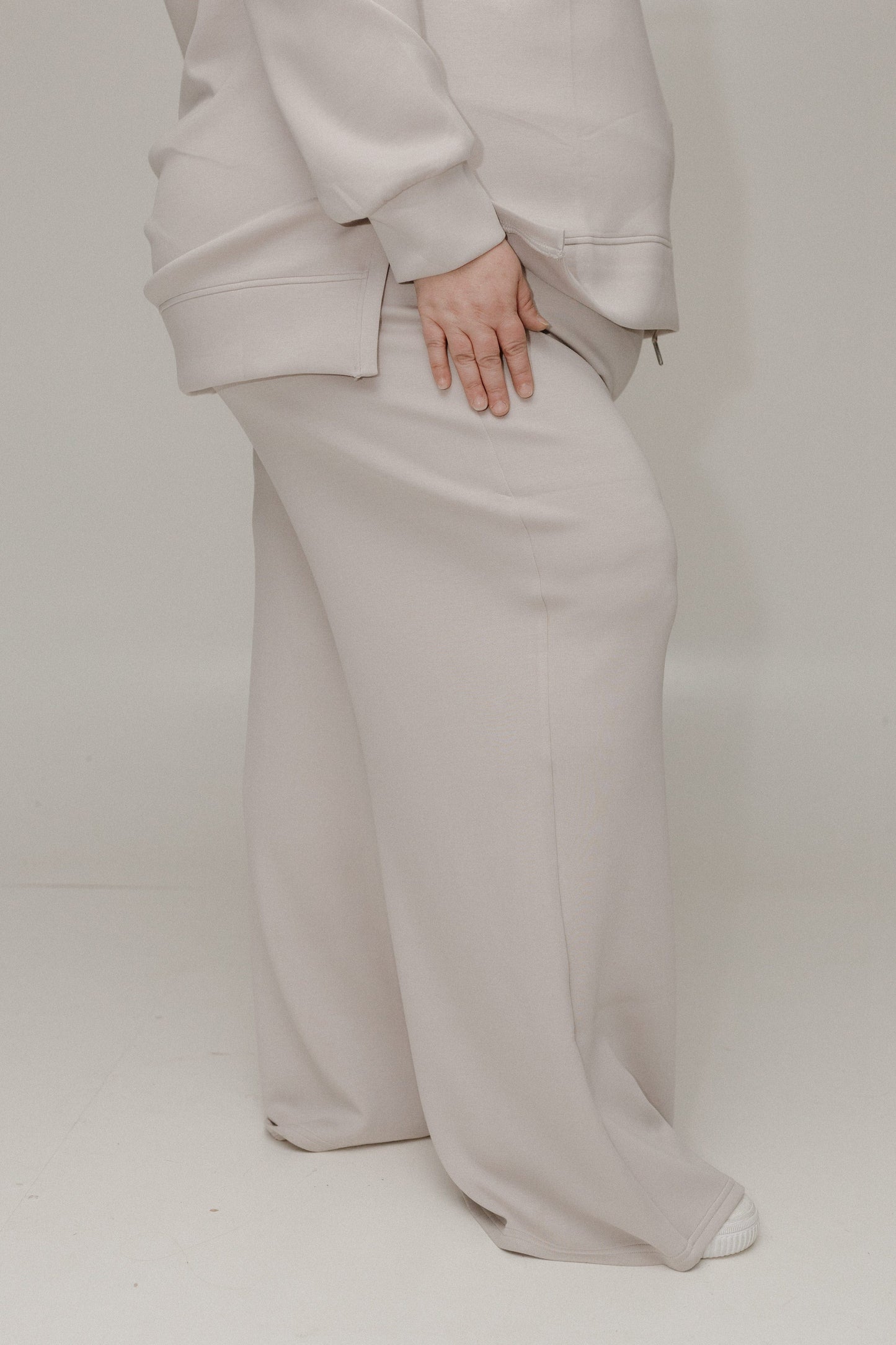 Side of athleisure pants against a white background