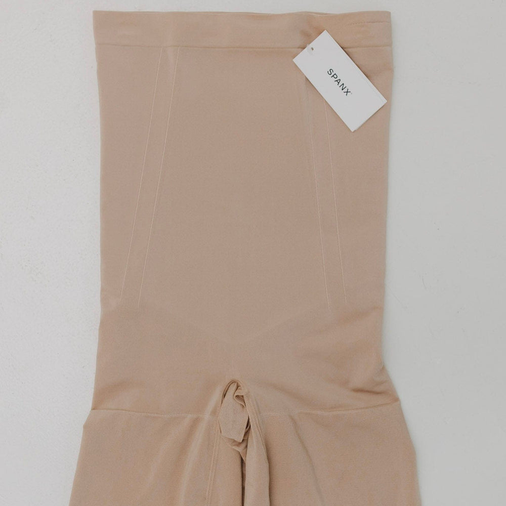 Beige fabric with a tie at the bottom on a white background