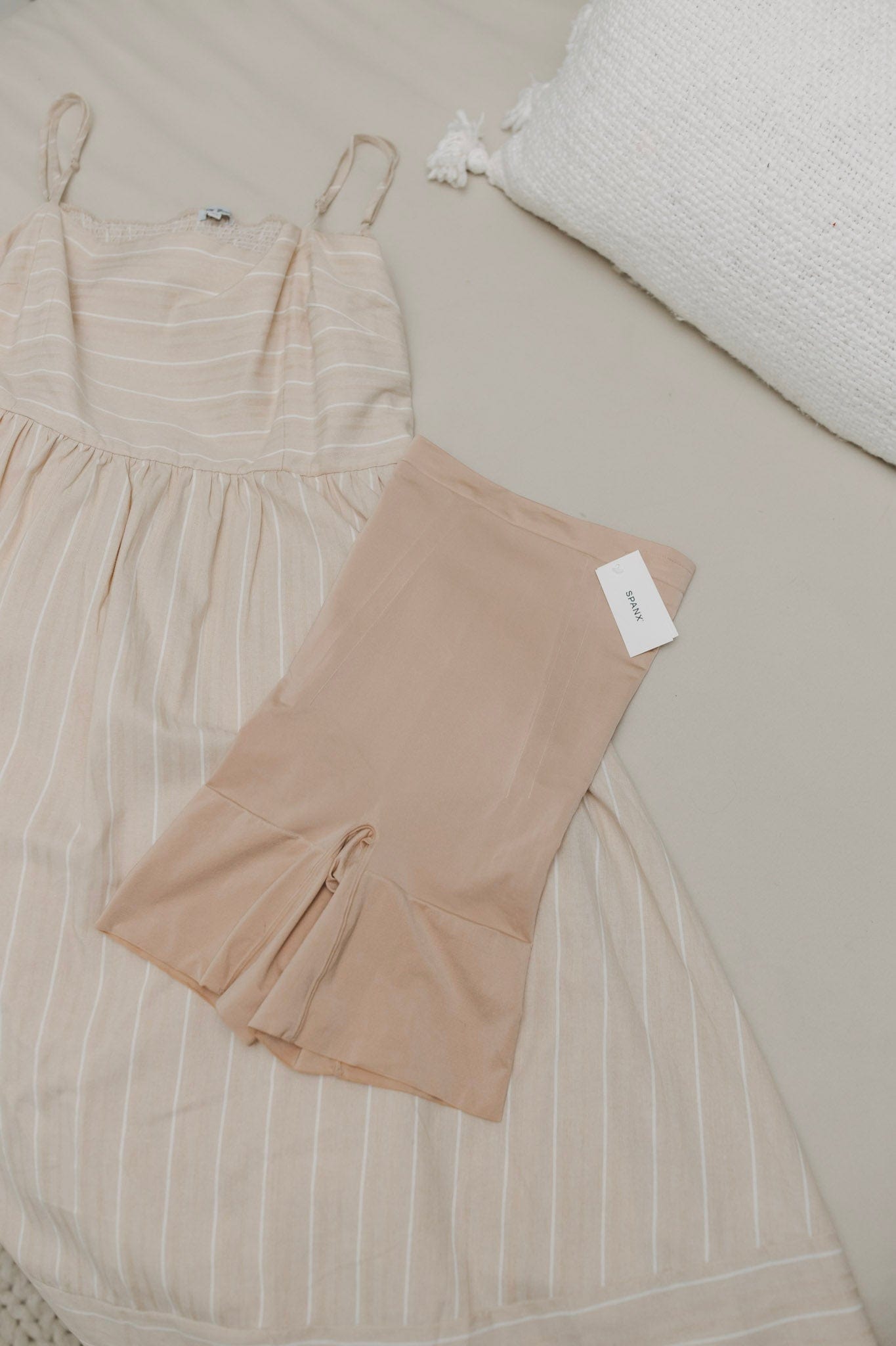 Beige dress with matching leggings on a neutral background