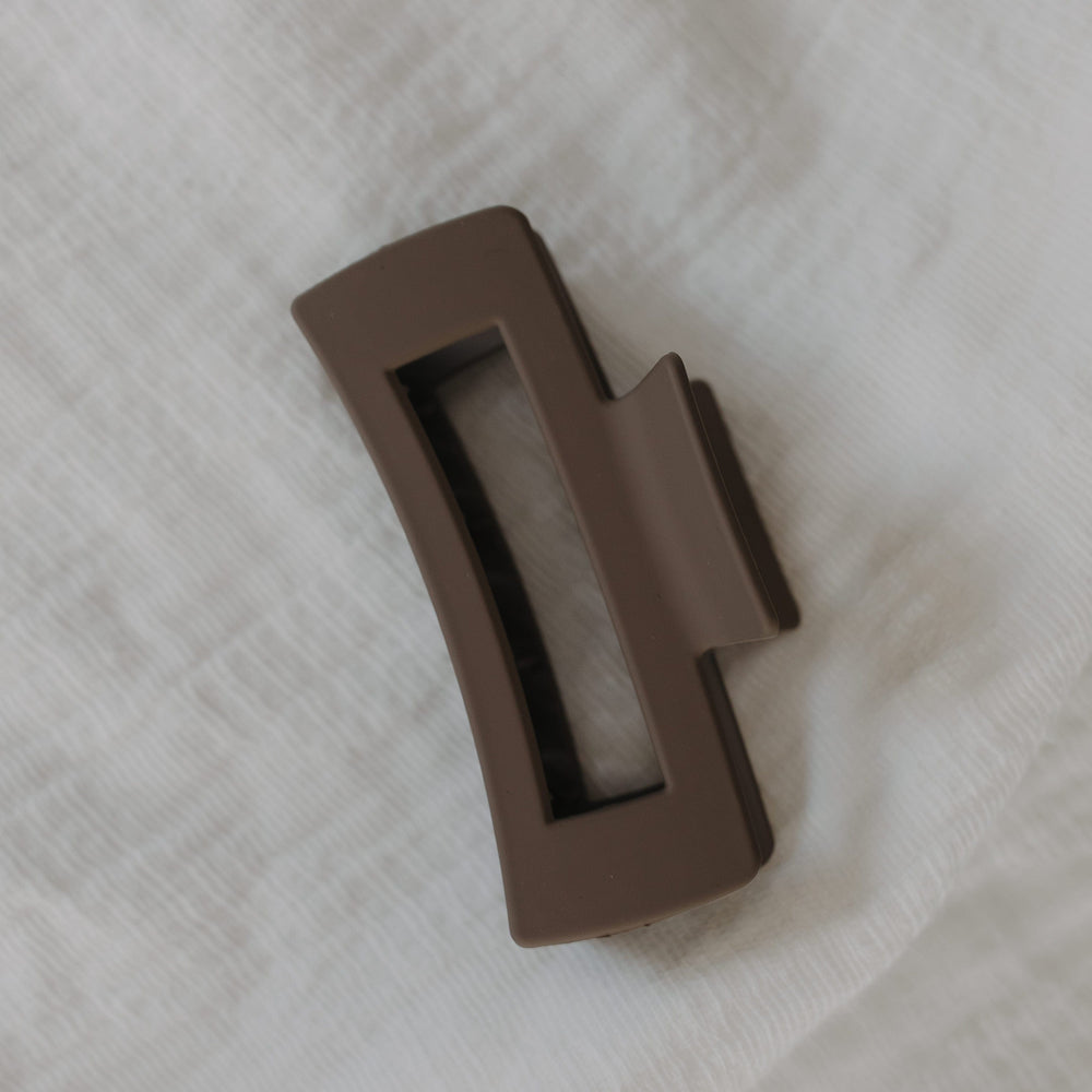 Stone claw clip on a light fabric background