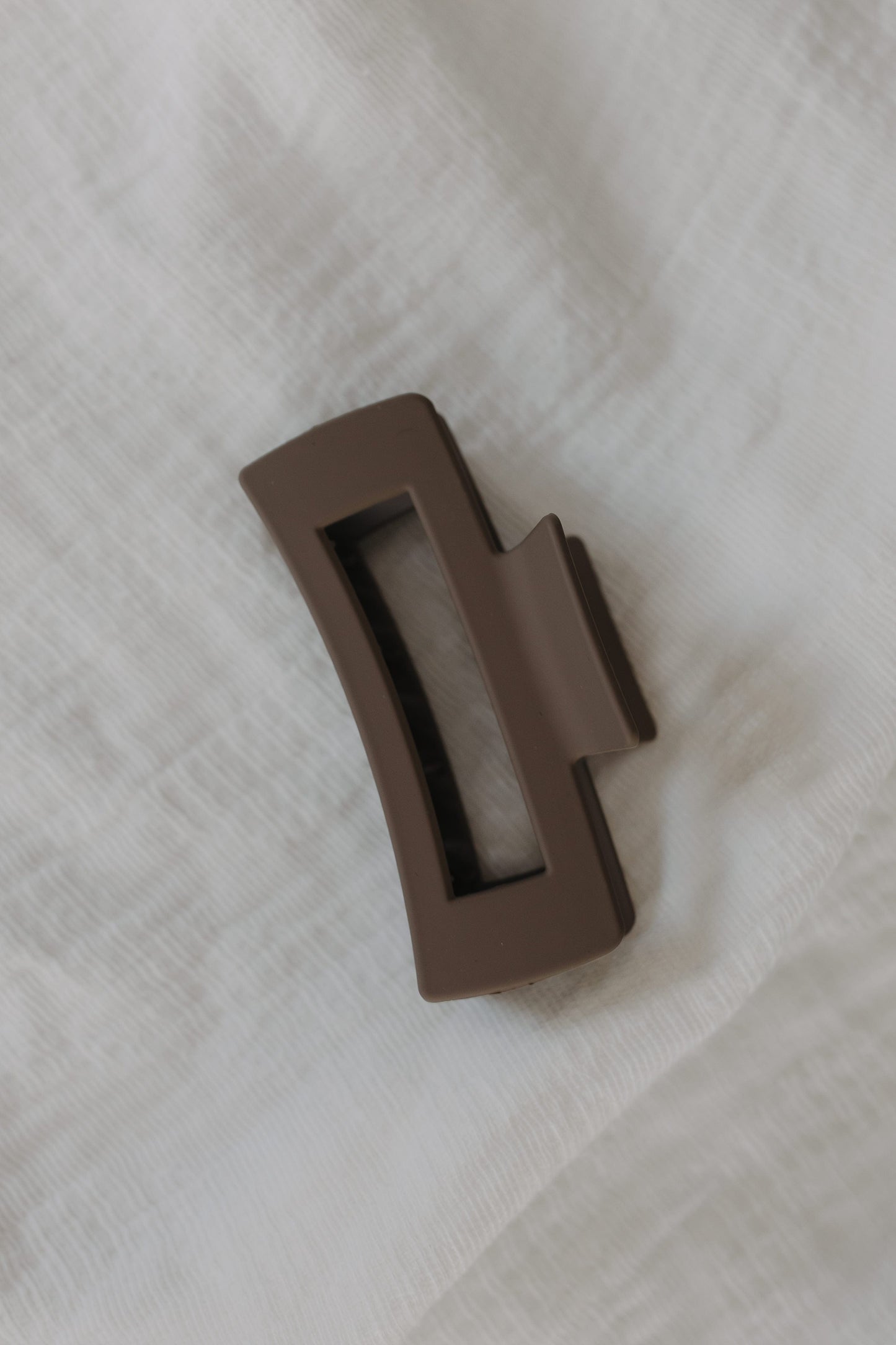 Stone claw clip on a light fabric background