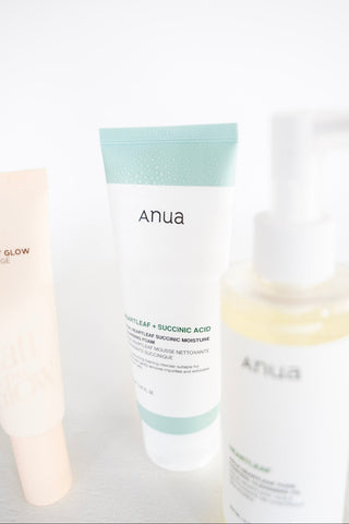 Three skincare products with 'ANUA' branding on a light background
