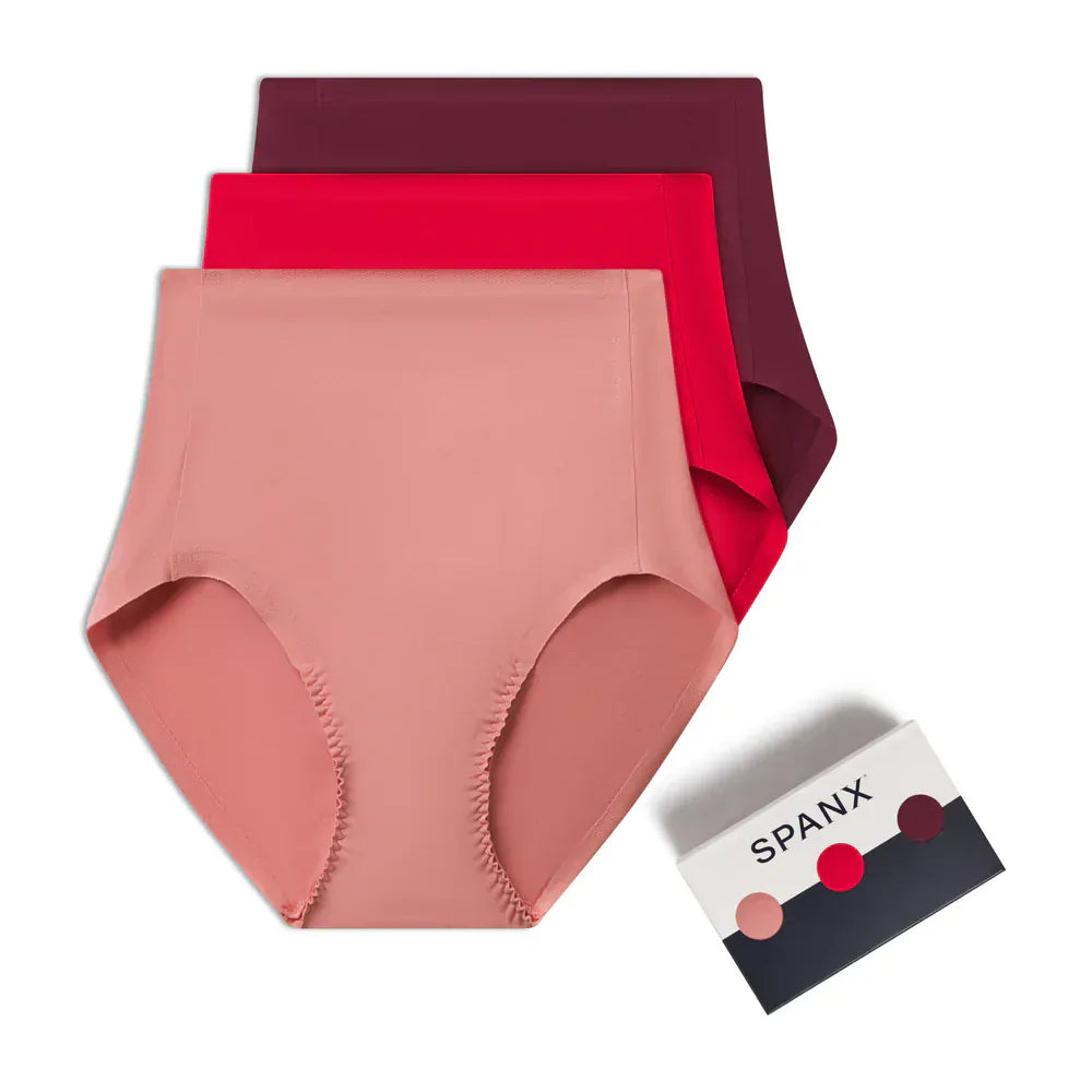 Three pairs of women's underwear in pink and red with a Spanx box on a white background.