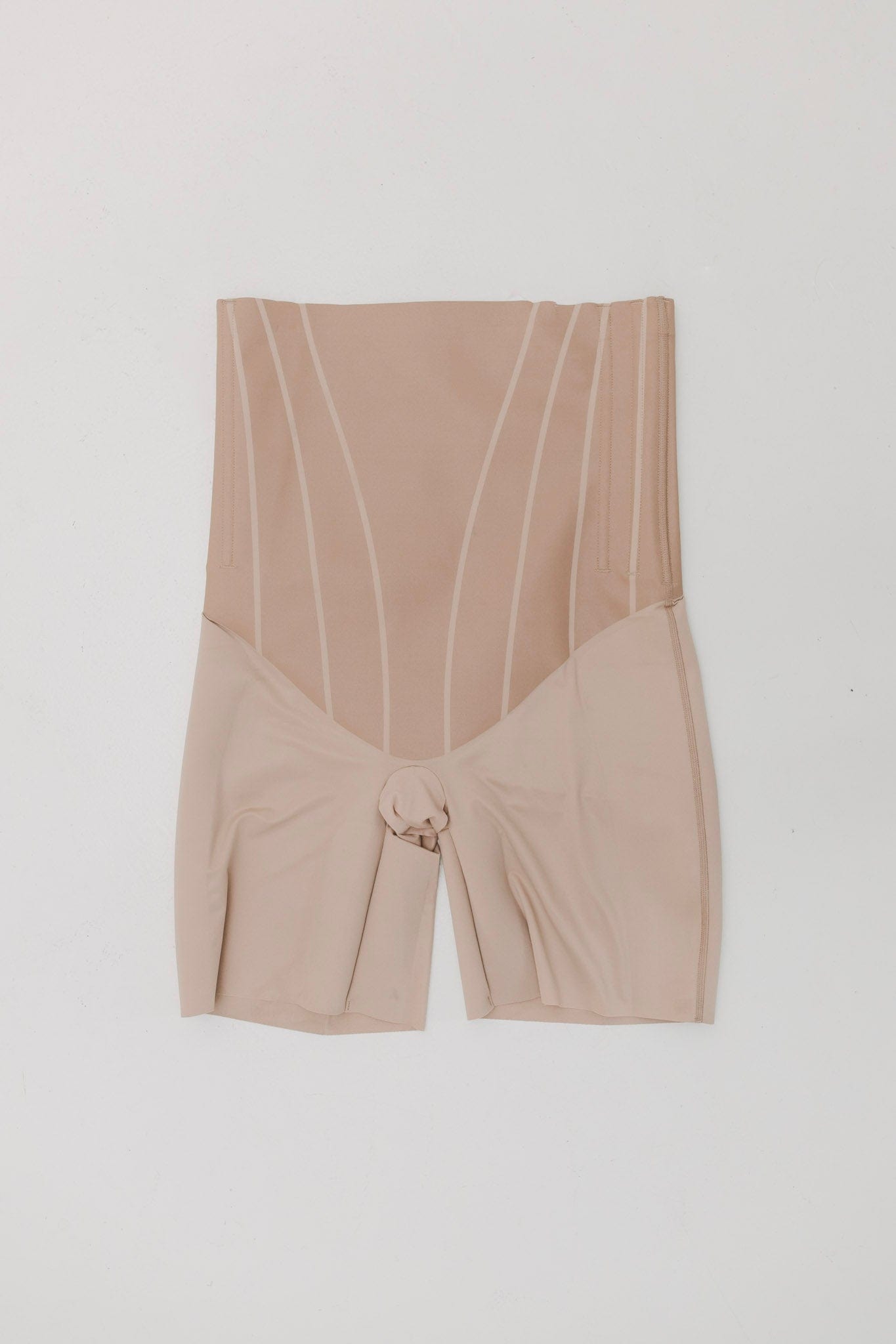 Beige high-waisted shorts with a tie detail on a white background