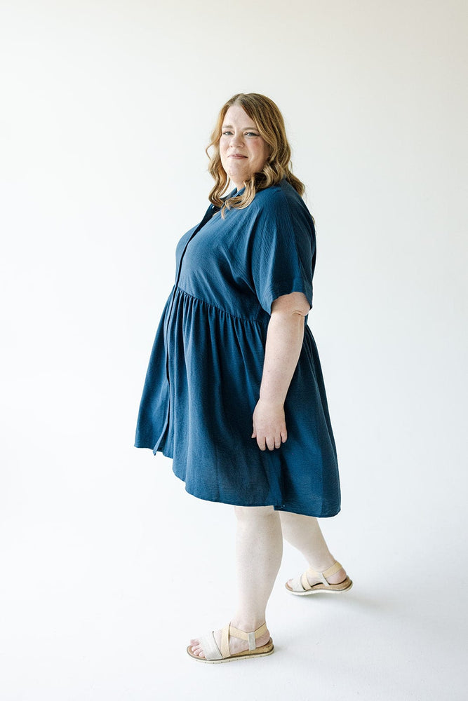 Person wearing a TEXTURED CHIFFON BUTTON FRONT DRESS IN INK from Mikarose, standing against a white background.