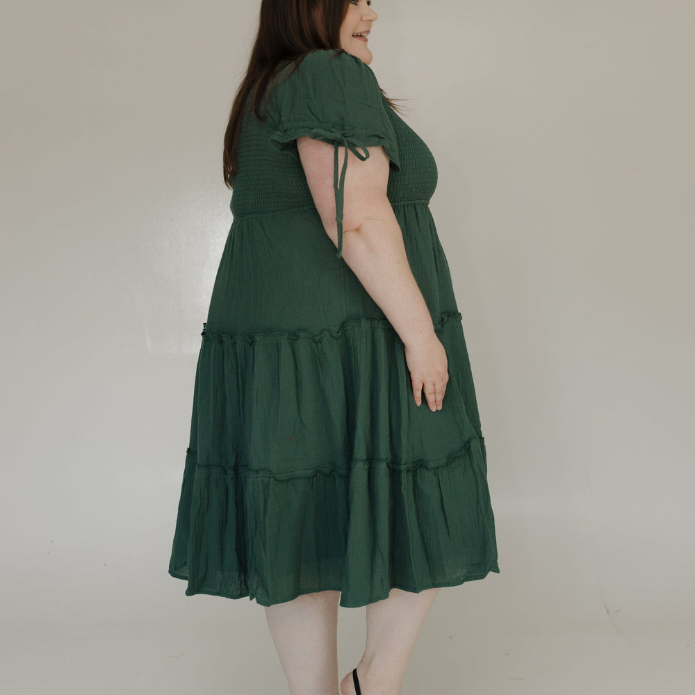 Woman wearing a green dress against a white background