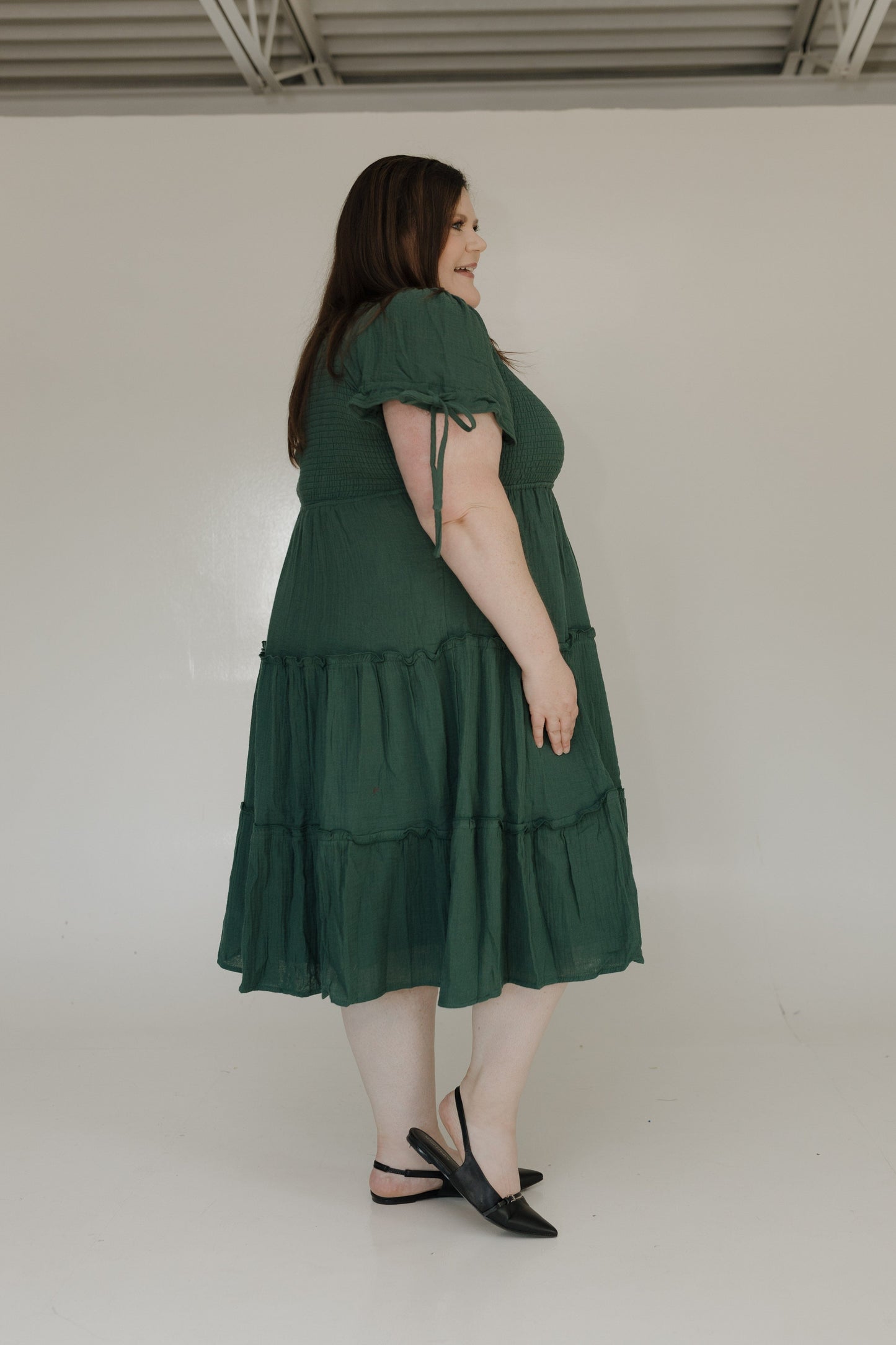Woman wearing a green dress against a white background