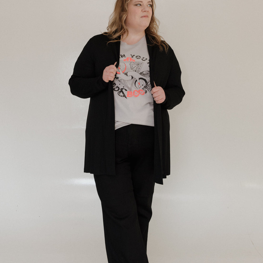 "WHEN YOU'RE BAD AND BOOJEE" GRAPHIC TEE woman wearing a gray t-shirt with graphic design and text on a plain background at Love Marlow