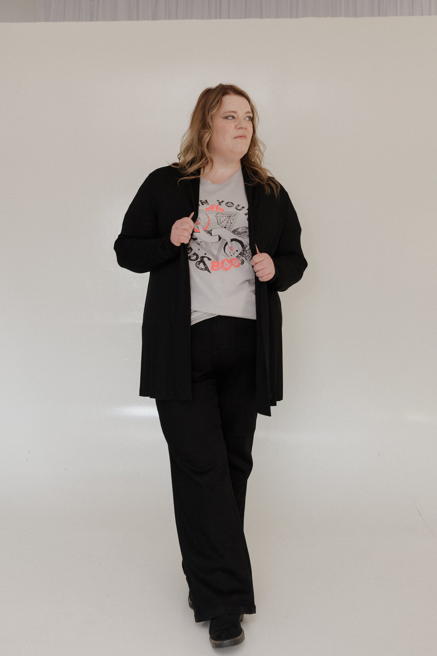 "WHEN YOU'RE BAD AND BOOJEE" GRAPHIC TEE woman wearing a gray t-shirt with graphic design and text on a plain background at Love Marlow