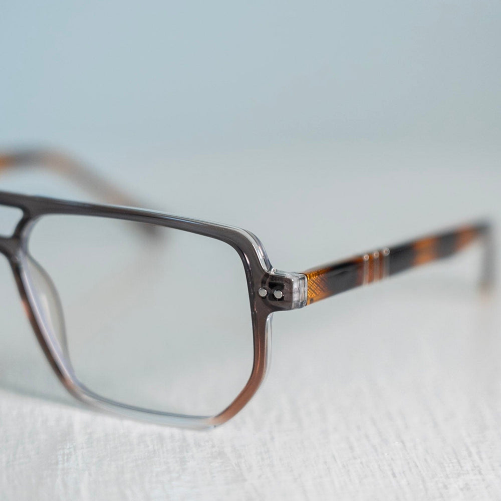 close up of blue light glasses with a tortoiseshell frame on a light background