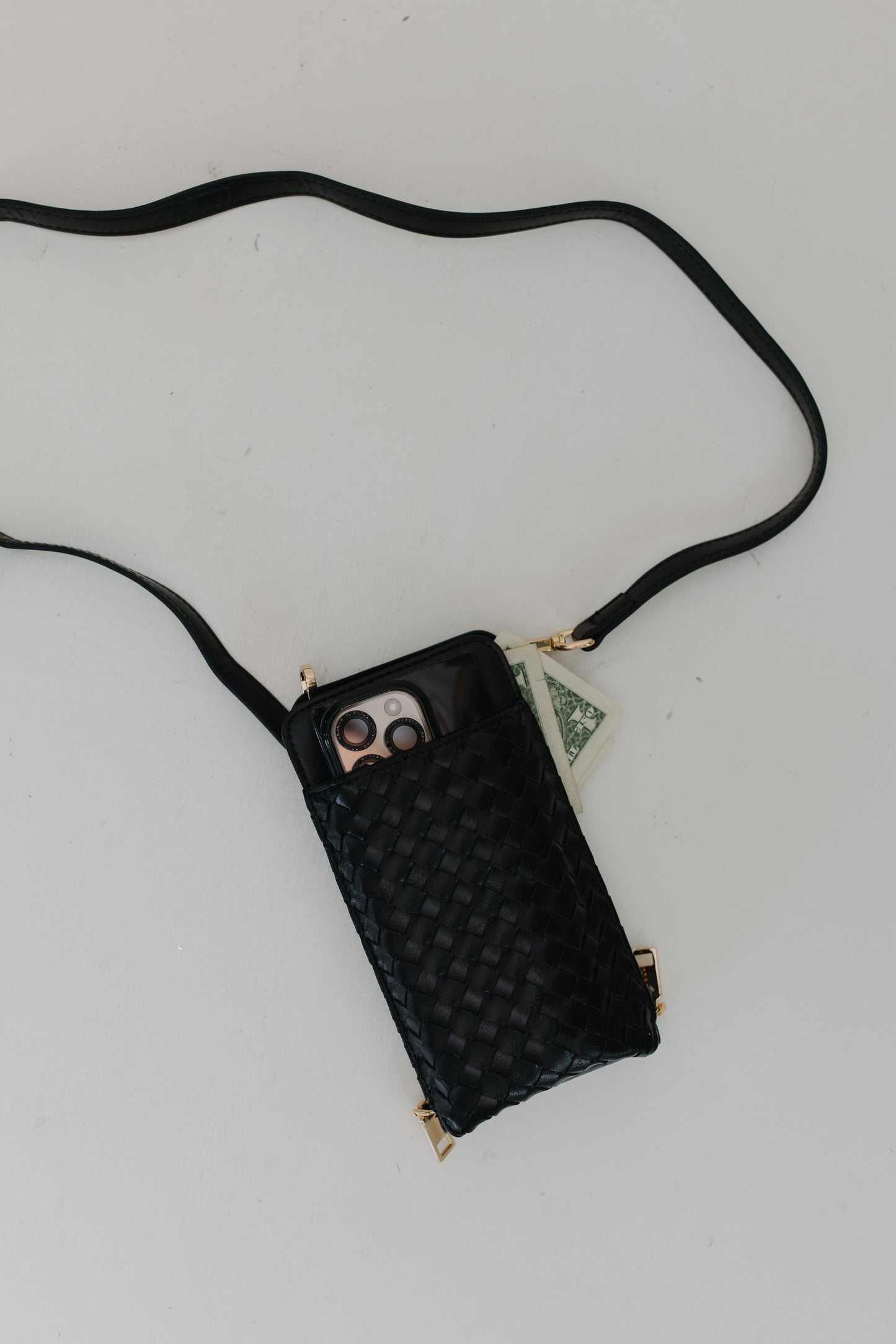 Black woven phone pouch with a strap on a light gray background