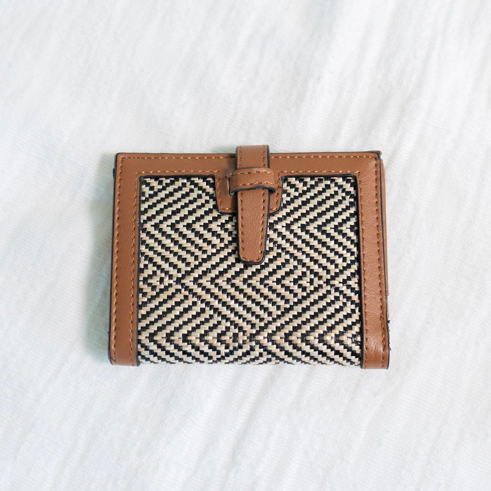 A classic pattern with a color twist makes this unique clutch simply understated. The classic black and natural color is a staple for your purse collection! Plus, so much room for your cards and cash! It has a slip closure and supple faux leather with a fun woven arrow pattern! 