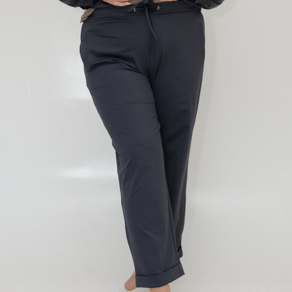 Person wearing a navy suit with a white background