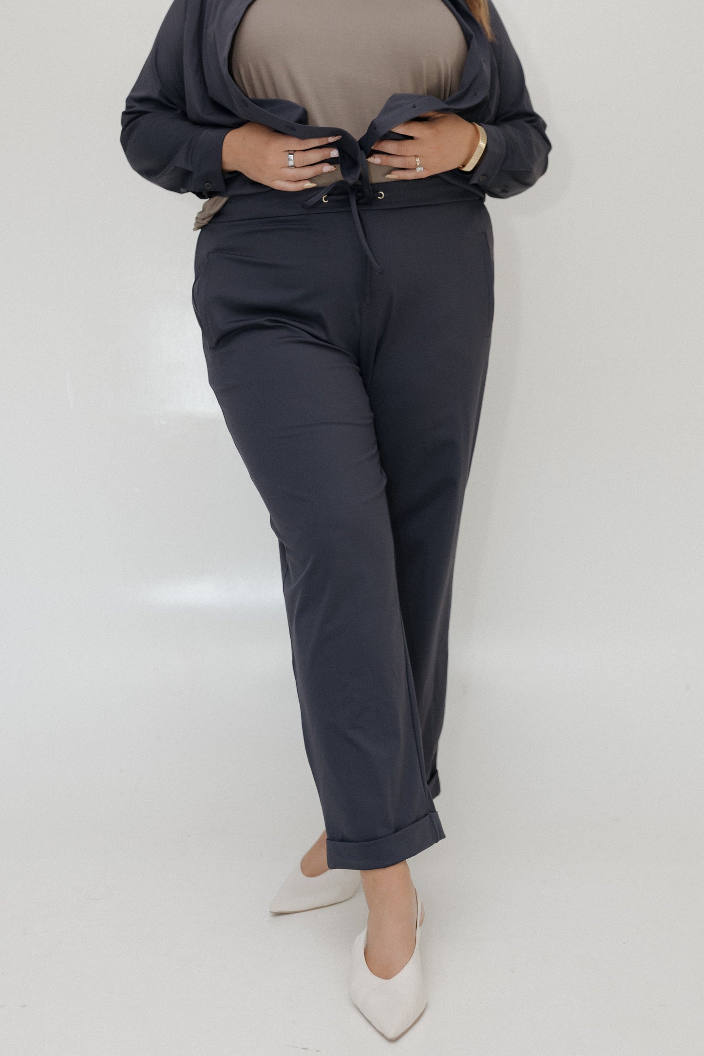 Person wearing a navy suit with a white background