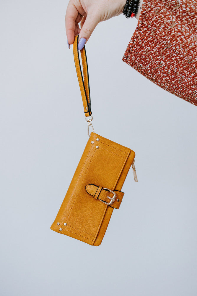 
            
                Load image into Gallery viewer, WRISTLET WALLET WITH BUCKLE DETAIL IN MUSTARD
            
        
