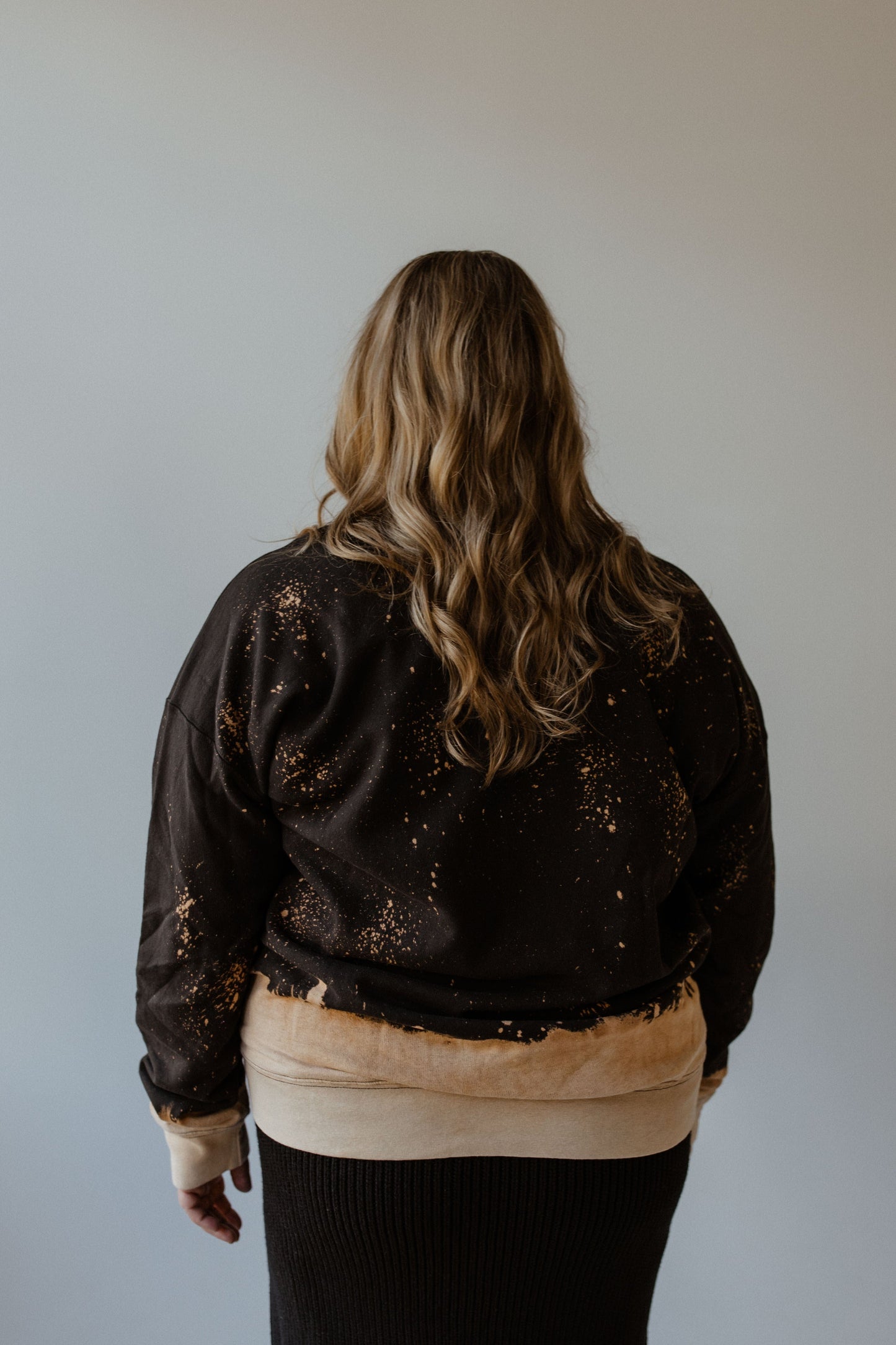 A person with long hair, wearing the 