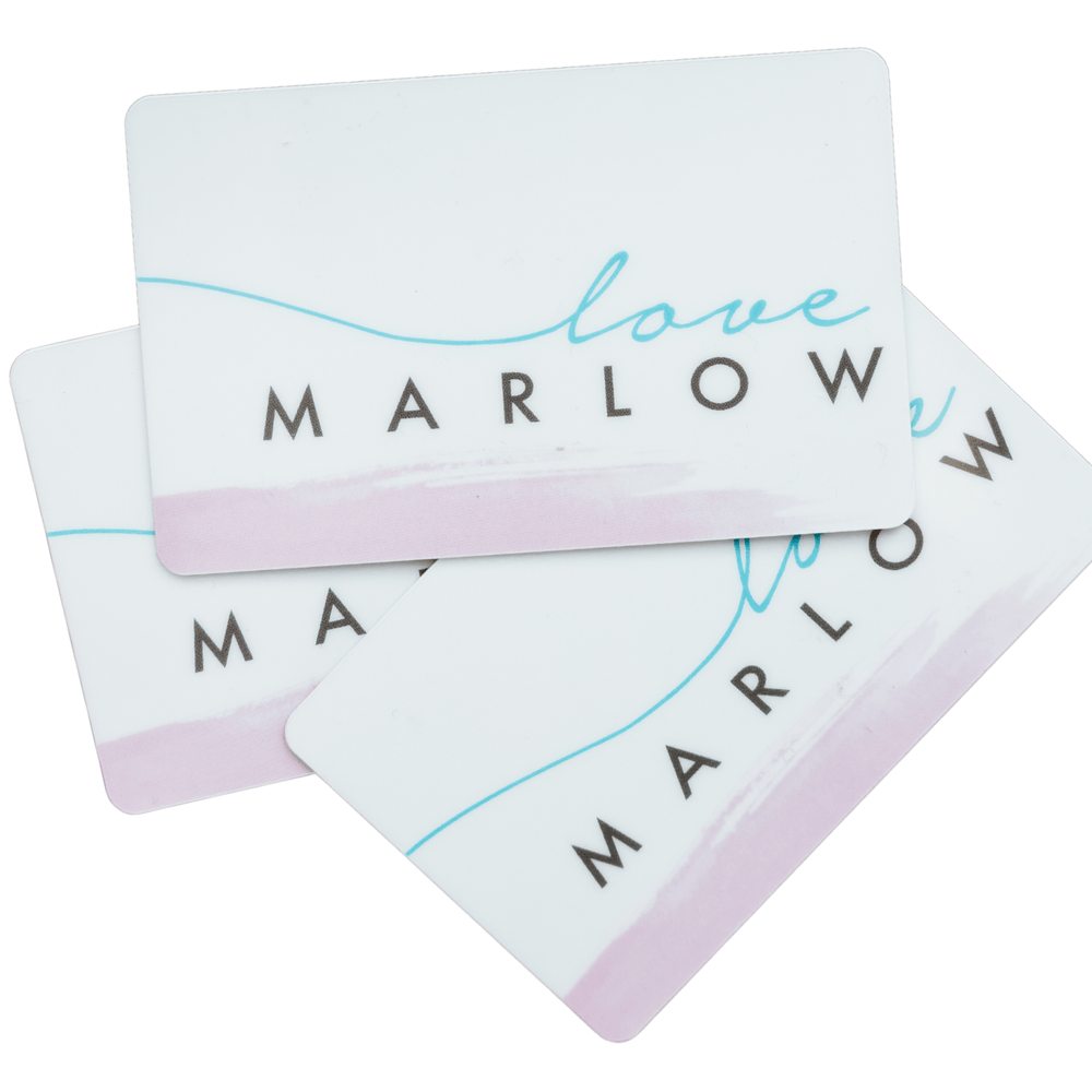 Three overlapping Gift Cards by Love Marlow, each adorned with the text "love Marlow" in blue and black. The cards feature a delicate faint pink section at the bottom, adding a touch of luxury to their design.