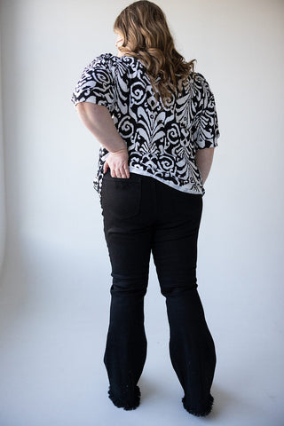 HIGH - RISE DISTRESSED FLARE JEAN WITH FRAYED HEM IN BLACK - Love Marlow