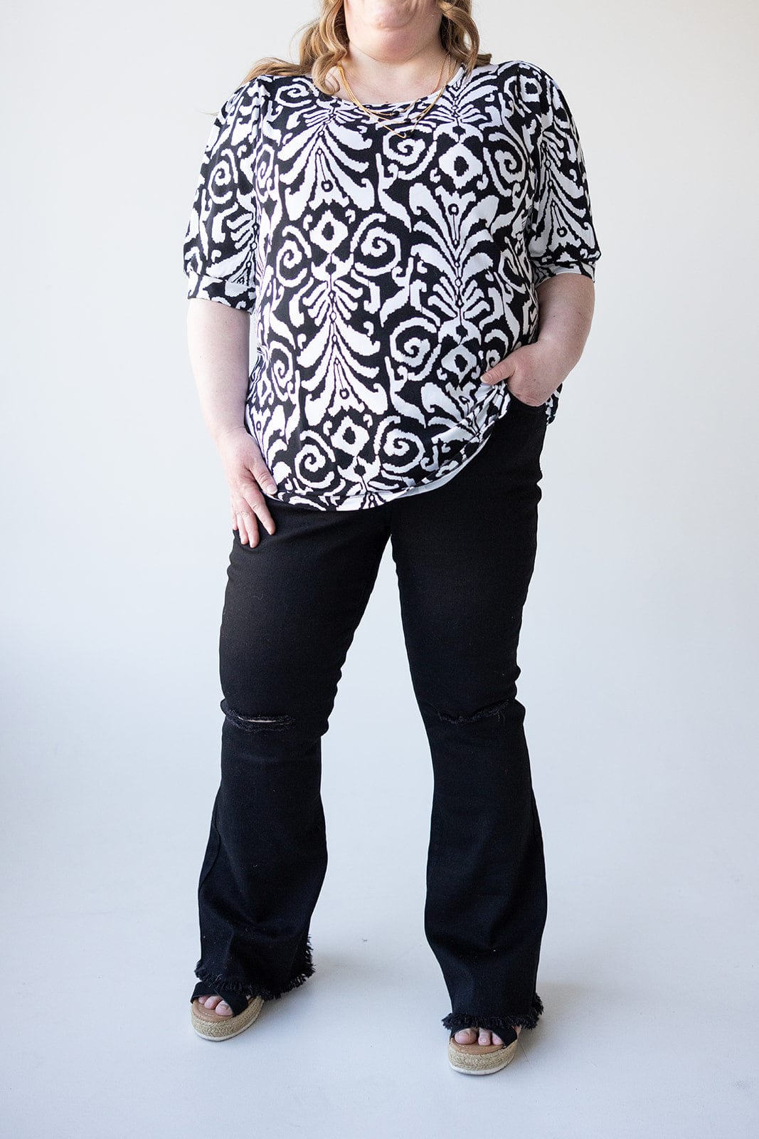 HIGH - RISE DISTRESSED FLARE JEAN WITH FRAYED HEM IN BLACK - Love Marlow