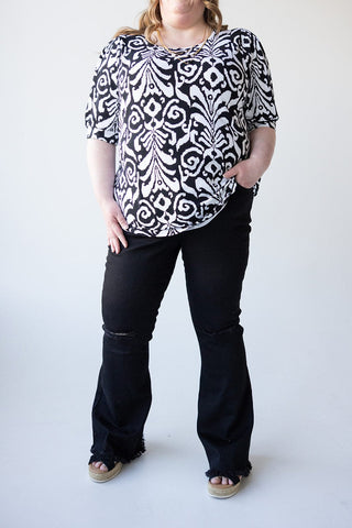 HIGH - RISE DISTRESSED FLARE JEAN WITH FRAYED HEM IN BLACK - Love Marlow