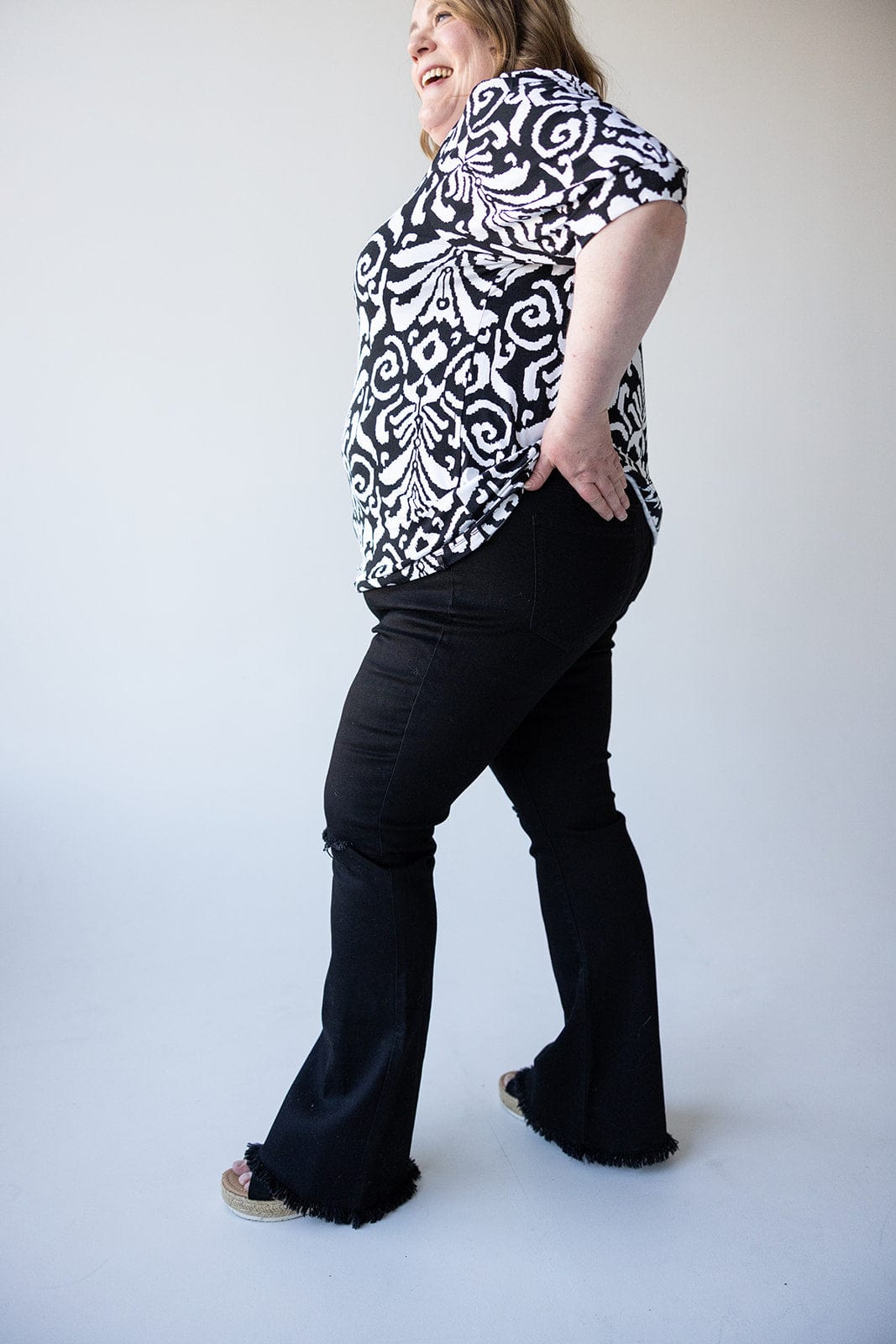 HIGH - RISE DISTRESSED FLARE JEAN WITH FRAYED HEM IN BLACK - Love Marlow