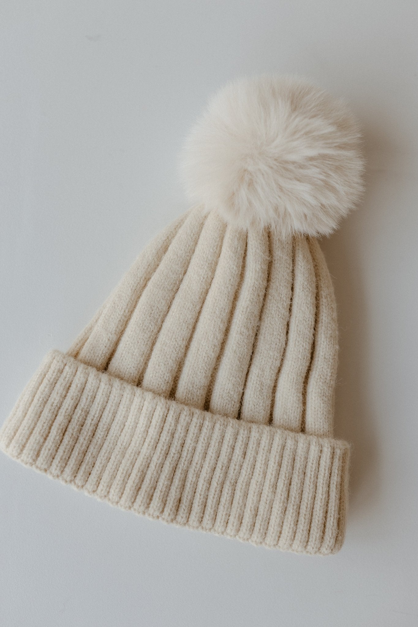 SOLID RIBBED KNIT BEANIE WITH PUFF IN IVORY - Love Marlow