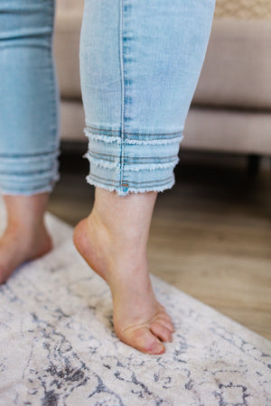 
            
                Load image into Gallery viewer, HIGH-RISE RELAXED SKINNY ANKLE JEAN WITH FRAYED HEM IN BLEACHED BLUE
            
        